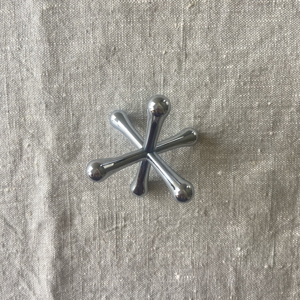 Metal jack paperweight.